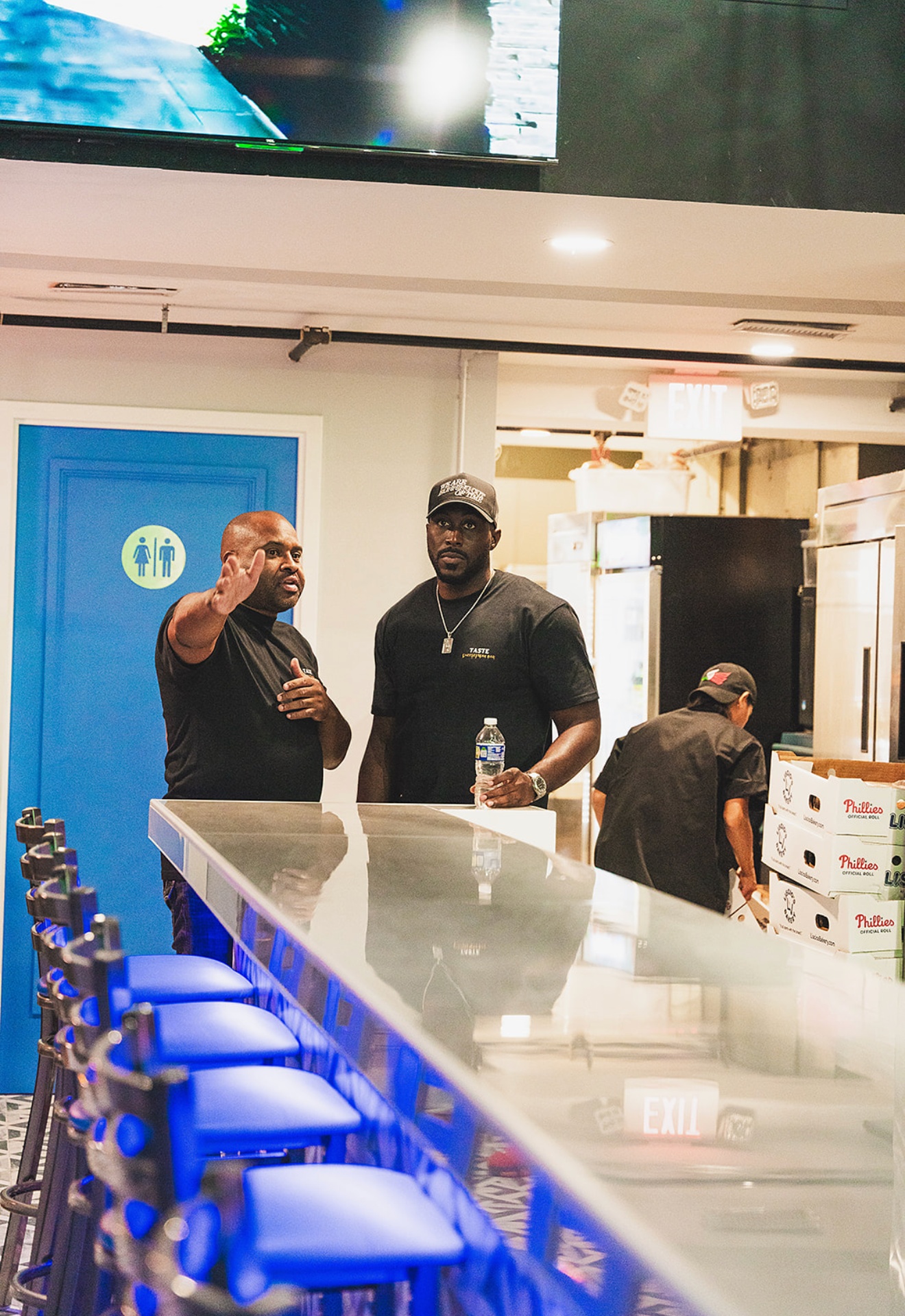 Kevin Dolce and Baron Herder, co-founders of Hi-Def Hospitality, on the floor at Taste Cheesesteak Bar